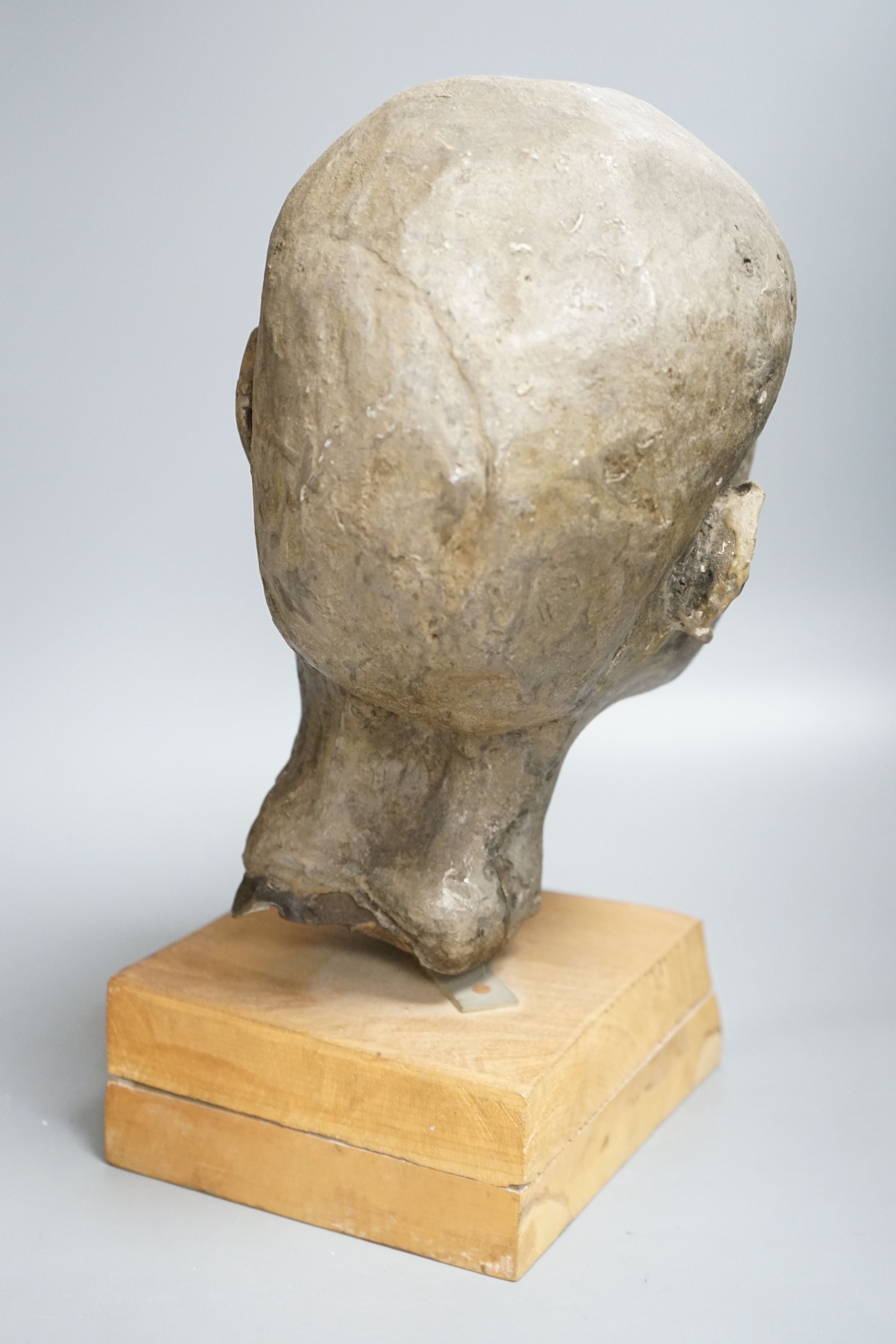 A composition sculpture of a child’s head 40 cm high including plinth